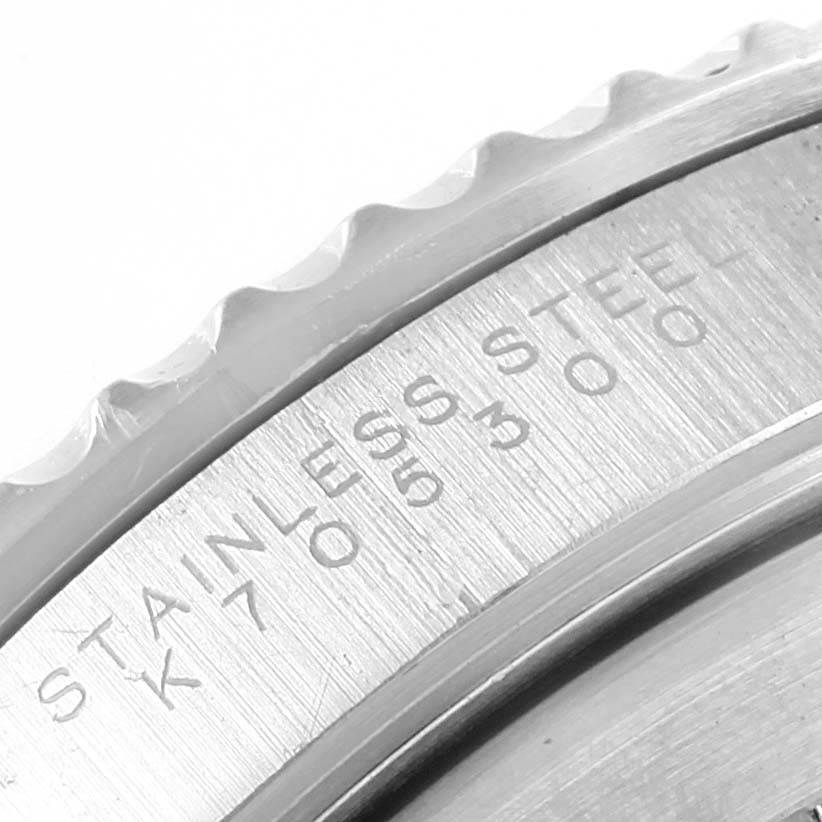 This close-up image of a Rolex Submariner 14060 Men's Stainless Steel Black Dial 14060 Men's Stainless Steel Black Dial watch shows part of the bezel and engravings on the stainless steel casing.