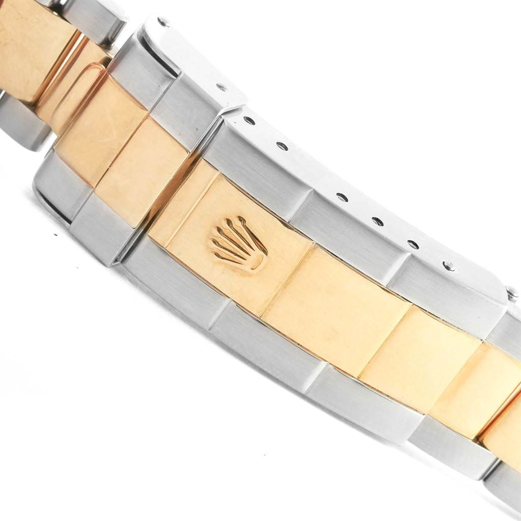 The image shows a close-up of the clasp and part of the bracelet of a Rolex Submariner 16613 Men's Steel and Gold (two tone) Blue Dial 16613 Men's Steel and Gold (two tone) Blue Dial, featuring a mix of gold and steel.