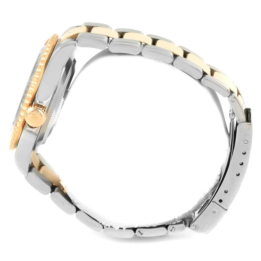 The image shows a side view of a Rolex Submariner 16613 Men's Steel and Gold (two tone) Blue Dial 16613 Men's Steel and Gold (two tone) Blue Dial watch, highlighting its metal bracelet and crown.