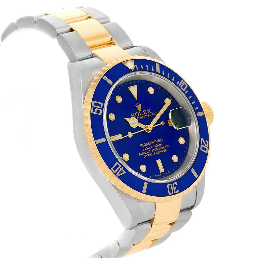 The image shows a Rolex Submariner 16613 Men's Steel and Gold (two tone) Blue Dial 16613 Men's Steel and Gold (two tone) Blue Dial watch at a three-quarter angle, highlighting its blue face, bezel, and two-tone metal bracelet.