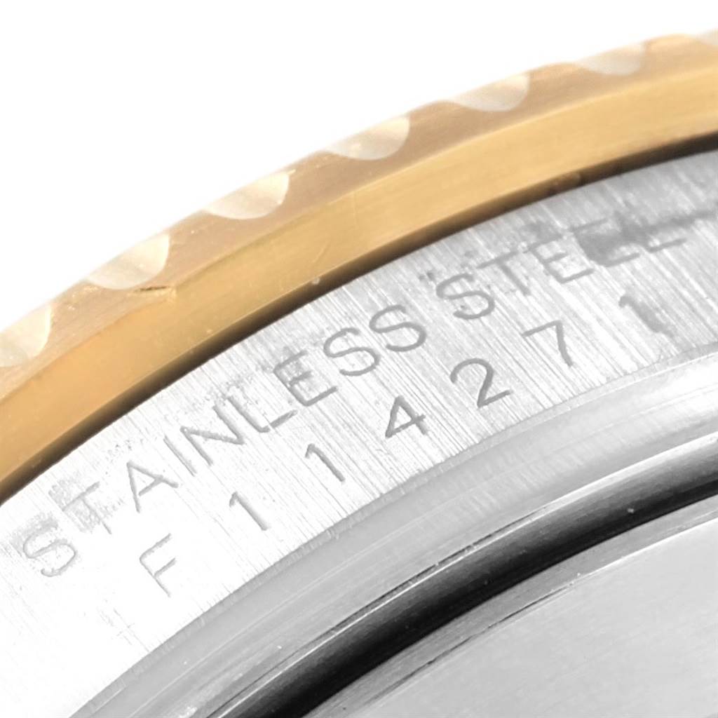 This close-up image shows the edge of the bezel and engraved details on the case back of a Rolex Submariner 16613 Men's Steel and Gold (two tone) Blue Dial 16613 Men's Steel and Gold (two tone) Blue Dial watch.