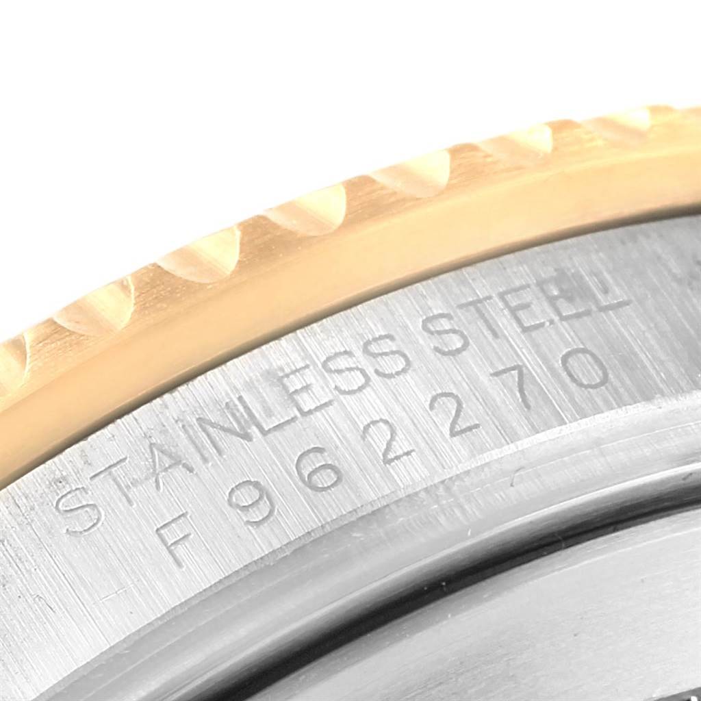 This close-up image shows the engraved serial number and "STAINLESS STEEL" marking on the bezel of a Rolex Submariner 16613 Men's Steel and Gold (two tone) Black Dial 16613 Men's Steel and Gold (two tone) Black Dial watch.