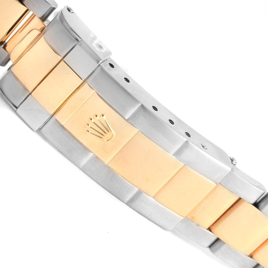 This image shows a close-up of the bracelet and clasp of a Rolex Submariner 16613 Men's Steel and Gold (two tone) Black Dial 16613 Men's Steel and Gold (two tone) Black Dial, highlighting the two-tone metal and logo.