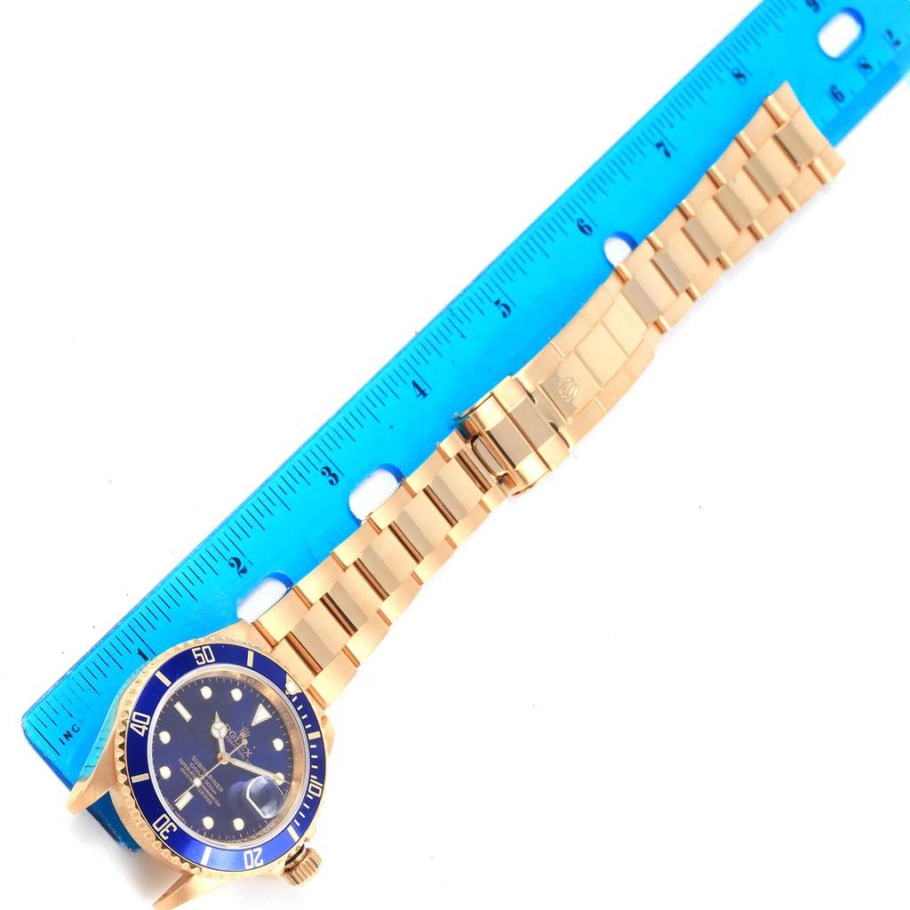 The image shows the full Rolex Submariner 16618 Men's Yellow Gold Blue Dial 16618 Men's Yellow Gold Blue Dial watch, positioned next to a ruler for measurement.