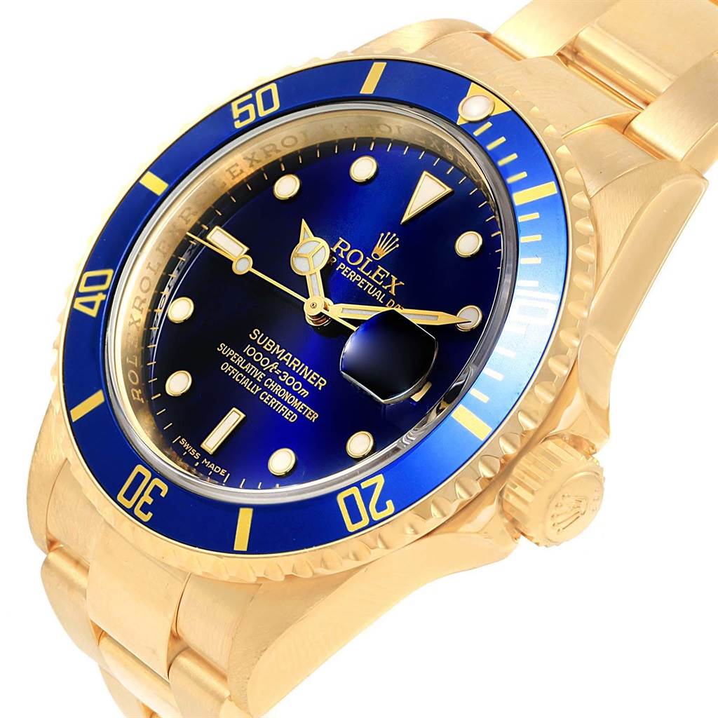 This image shows a Rolex Submariner 16618 Men's Yellow Gold Blue Dial 16618 Men's Yellow Gold Blue Dial watch at an oblique angle, highlighting the blue dial and bezel, and gold case and bracelet.