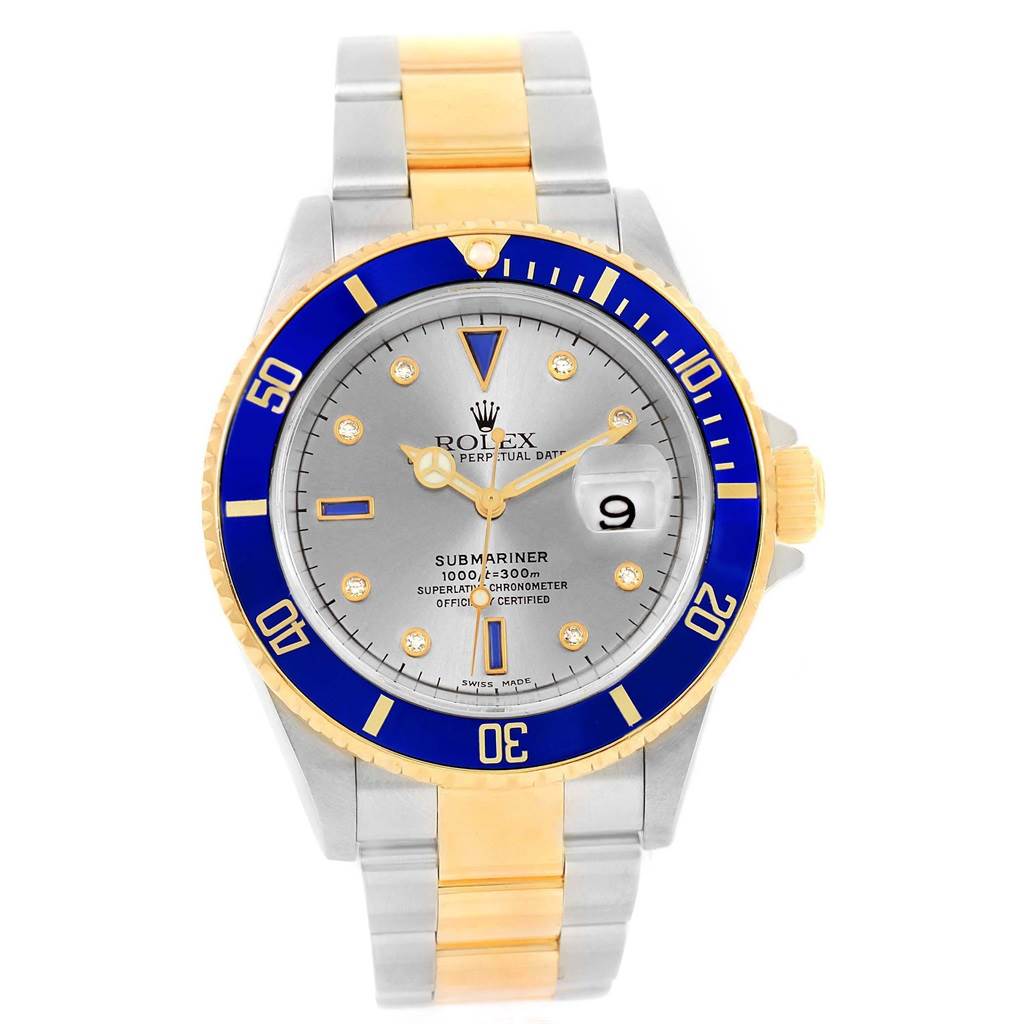 The image shows the face and bracelet of a Rolex Submariner 16613 Men's Steel and Gold (two tone) Grey Dial 16613 Men's Steel and Gold (two tone) Grey Dial watch, featuring a blue bezel, grey dial, and two-tone metal band.