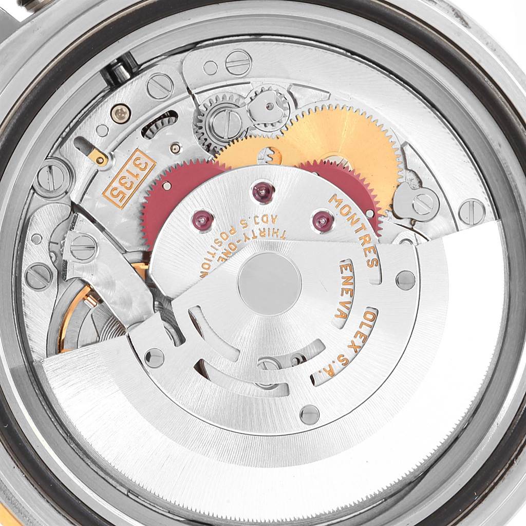 This image shows the Rolex Submariner 16613 Men's Steel and Gold (two tone) Grey Dial 16613 Men's Steel and Gold (two tone) Grey Dial watch movement from a close-up angle, revealing the intricate gears and internal components.