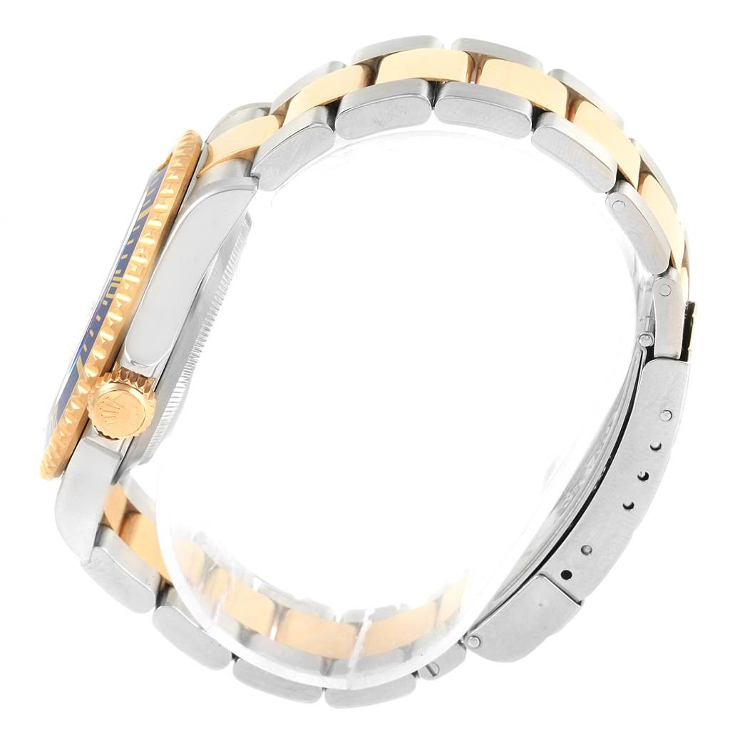 A side view of a Rolex Submariner 16613 Men's Steel and Gold (two tone) Grey Dial 16613 Men's Steel and Gold (two tone) Grey Dial showing the crown, case, and two-tone bracelet.