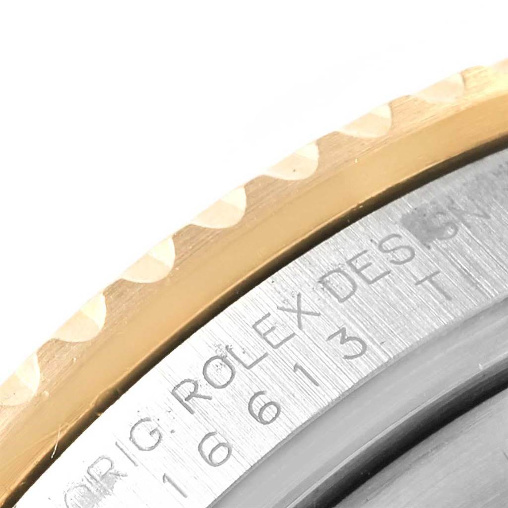 This image shows a close-up view of the edge and part of the case back of a Rolex Submariner 16613 Men's Steel and Gold (two tone) Grey Dial 16613 Men's Steel and Gold (two tone) Grey Dial watch.