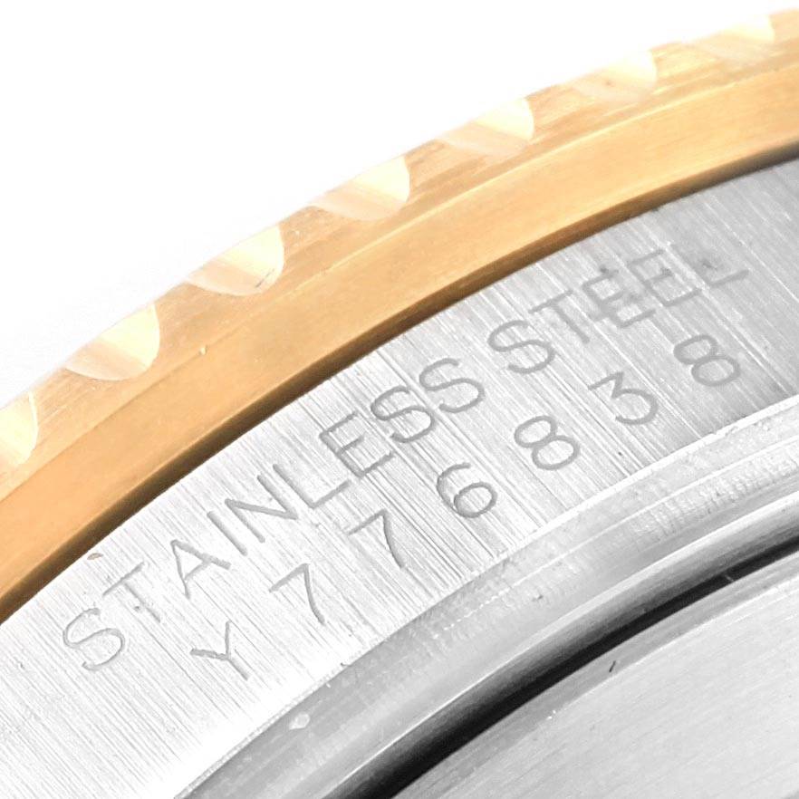 This close-up image shows the engraved bezel and stainless steel part of a Rolex Submariner 16613 Men's Steel and Gold (two tone) Blue Dial 16613 Men's Steel and Gold (two tone) Blue Dial watch.