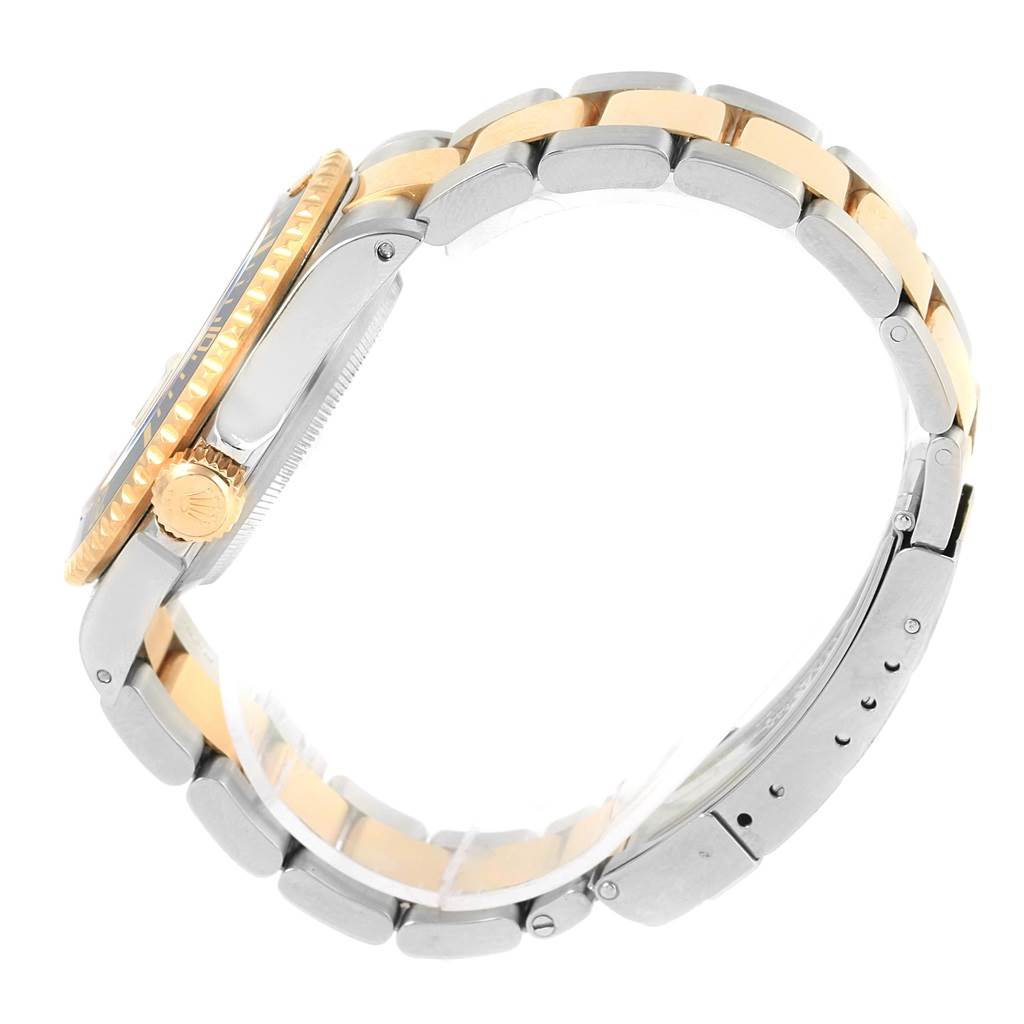 The image shows a side view of a Rolex Submariner 16613 Men's Steel and Gold (two tone) Blue Dial 16613 Men's Steel and Gold (two tone) Blue Dial, highlighting its case, crown, and two-tone band.