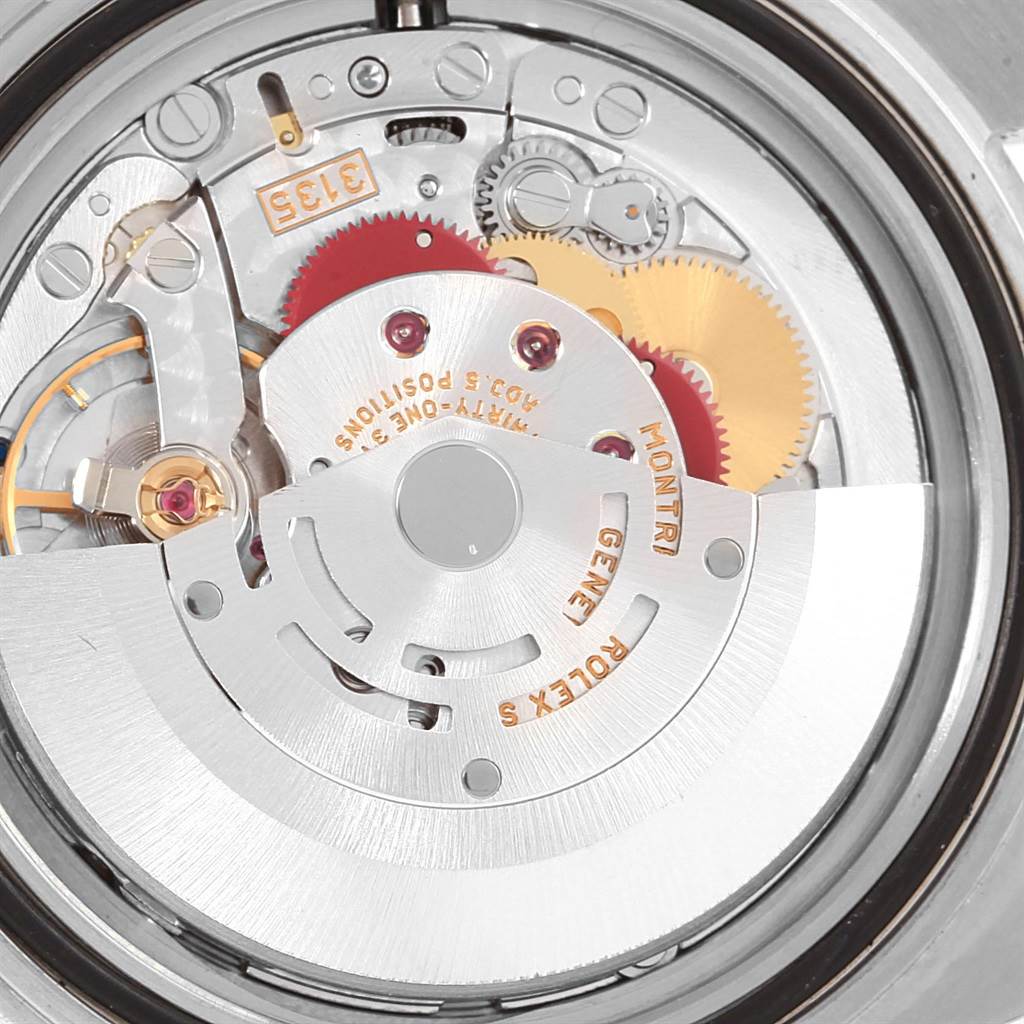 The image shows the movement mechanism of a Rolex Submariner 16613 Men's Steel and Gold (two tone) Blue Dial 16613 Men's Steel and Gold (two tone) Blue Dial watch, highlighting gears and intricate components.