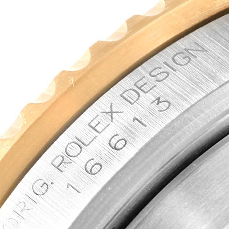 This close-up image shows the engraving on the side of the bezel of a Rolex Submariner 16613 Men's Steel and Gold (two tone) Blue Dial 16613 Men's Steel and Gold (two tone) Blue Dial watch.