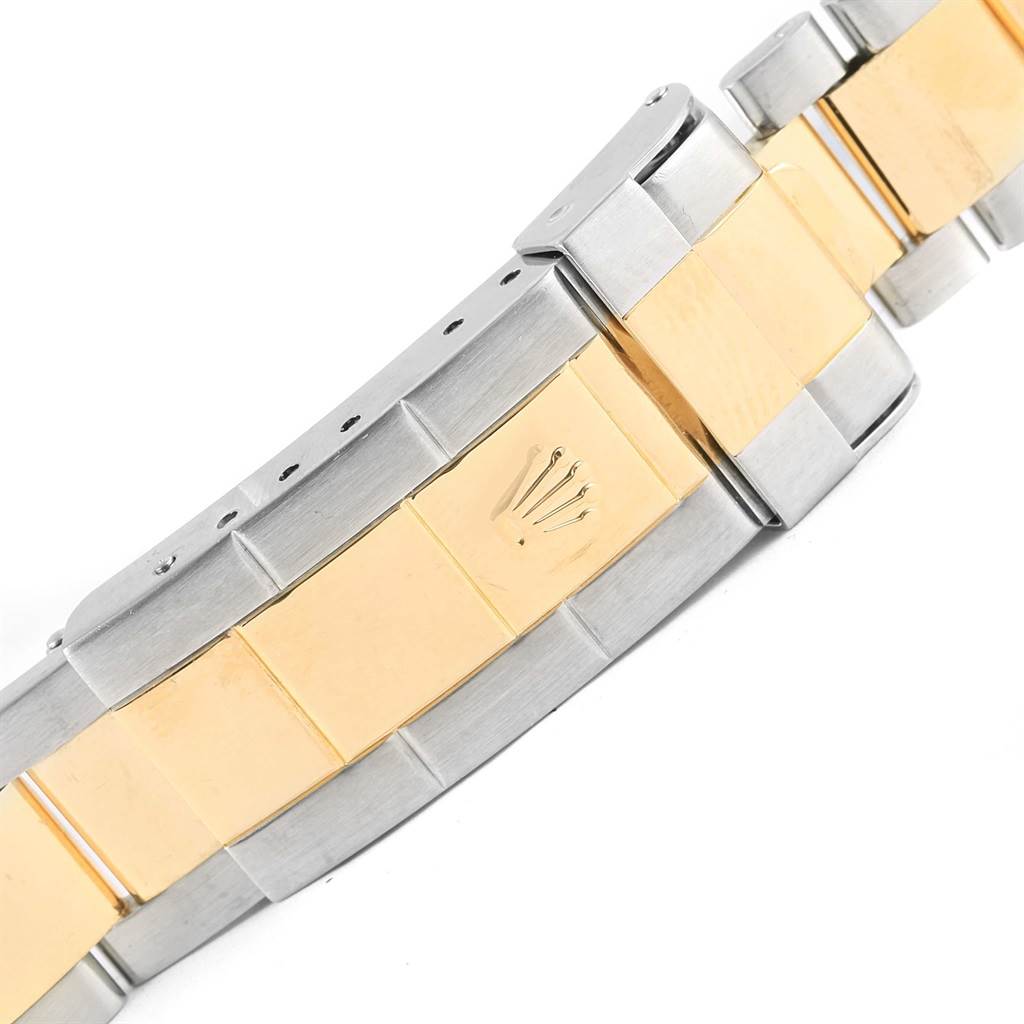 The image shows a close-up of the bracelet and clasp of a Rolex Submariner 16613 Men's Steel and Gold (two tone) Black Dial 16613 Men's Steel and Gold (two tone) Black Dial, highlighting its two-tone metal design.