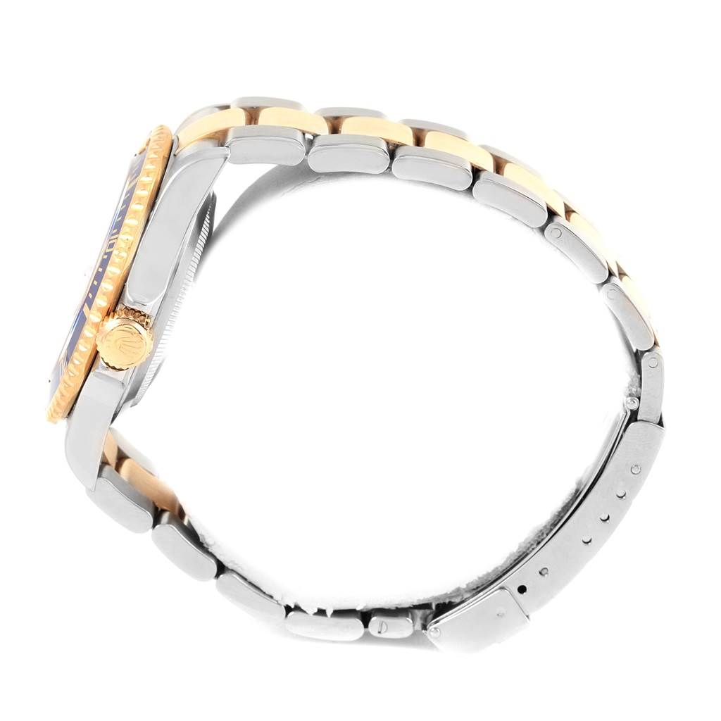 The image shows a side view of the Rolex Submariner 16613 Men's Steel and Gold (two tone) Blue Dial 16613 Men's Steel and Gold (two tone) Blue Dial, highlighting the crown, case, and two-tone bracelet.