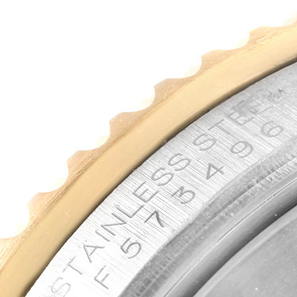 Close-up image of a Rolex Submariner 16613 Men's Steel and Gold (two tone) Blue Dial 16613 Men's Steel and Gold (two tone) Blue Dial showing the side of the bezel and part of the engraved stainless steel case.