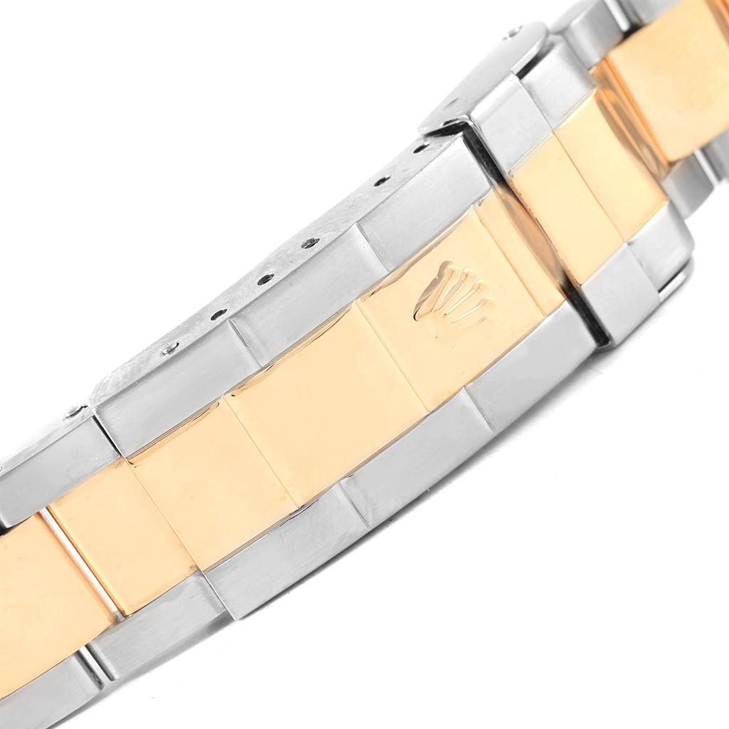 The image shows a close-up of the bracelet of a Rolex Submariner 16613 Men's Steel and Gold (two tone) Blue Dial 16613 Men's Steel and Gold (two tone) Blue Dial, featuring a two-tone design with the Rolex logo.