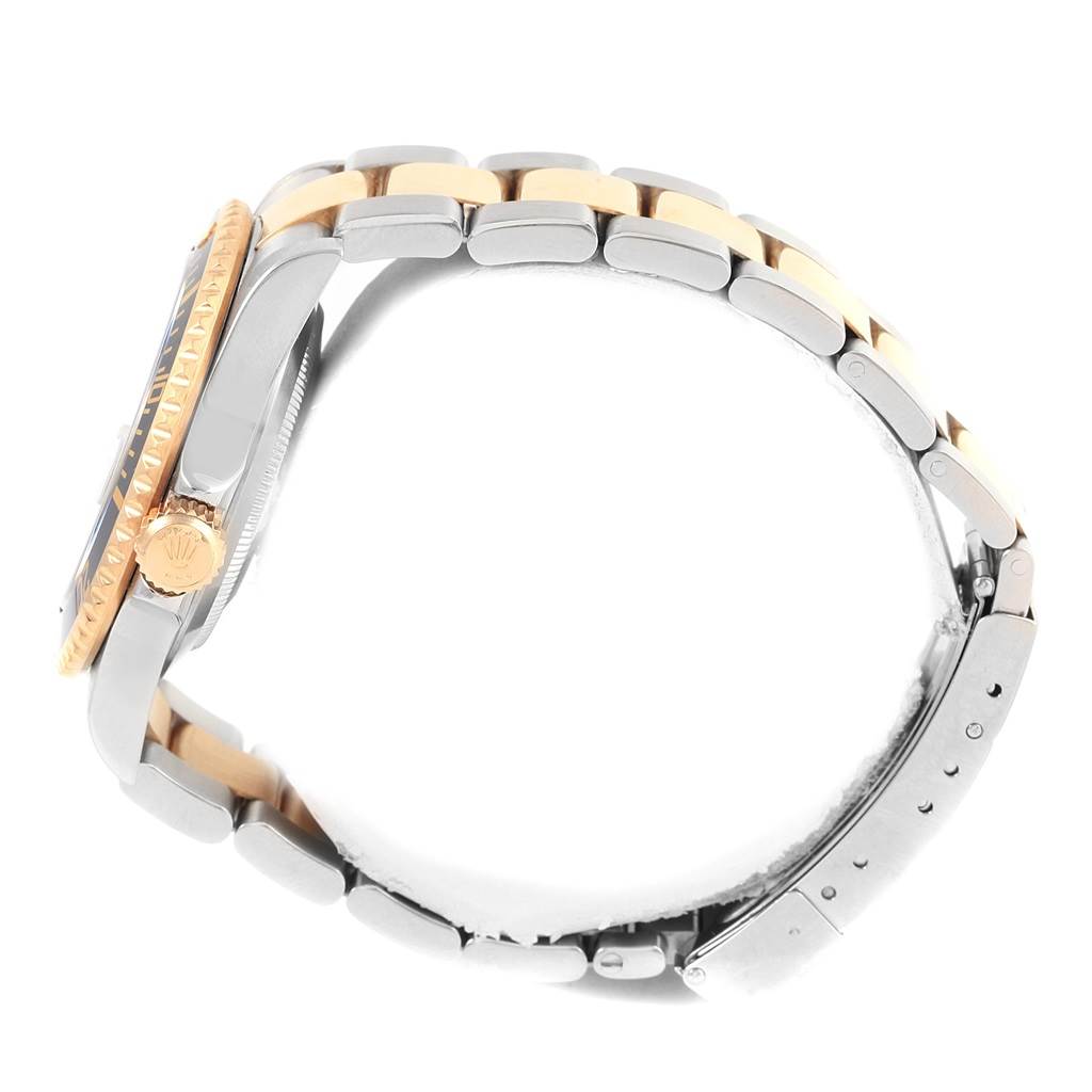 The image shows a Rolex Submariner 16613 Men's Steel and Gold (two tone) Black Dial 16613 Men's Steel and Gold (two tone) Black Dial watch from a side angle, highlighting the crown, bezel, and part of the metal bracelet.