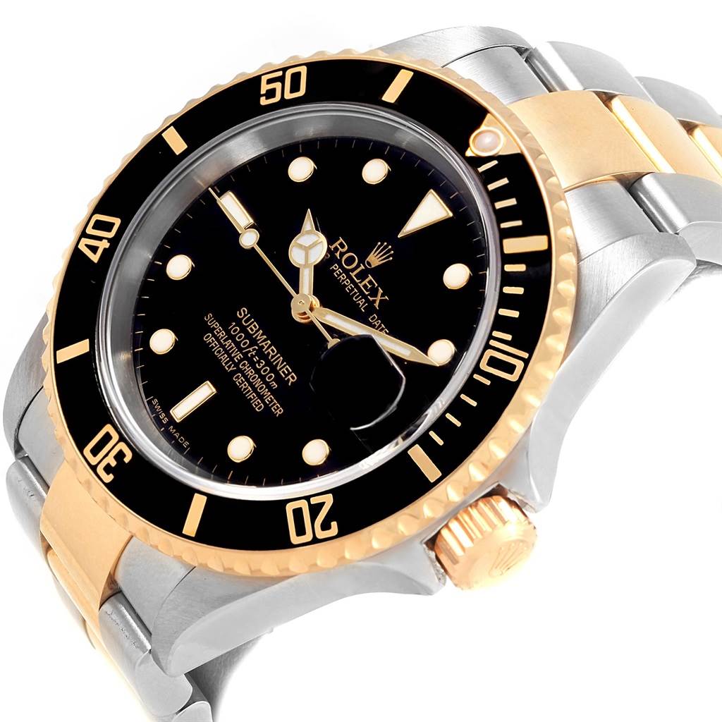 The image shows a Rolex Submariner 16613 Men's Steel and Gold (two tone) Black Dial 16613 Men's Steel and Gold (two tone) Black Dial watch angled to display its face, bezel, crown, and part of the bracelet.