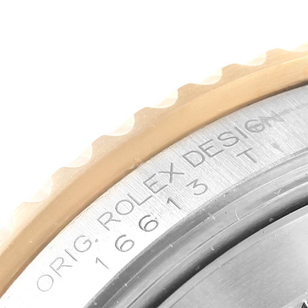 The image shows a close-up of the bezel and case side of a Rolex Submariner 16613 Men's Steel and Gold (two tone) Black Dial 16613 Men's Steel and Gold (two tone) Black Dial, displaying the engraved model and brand details.