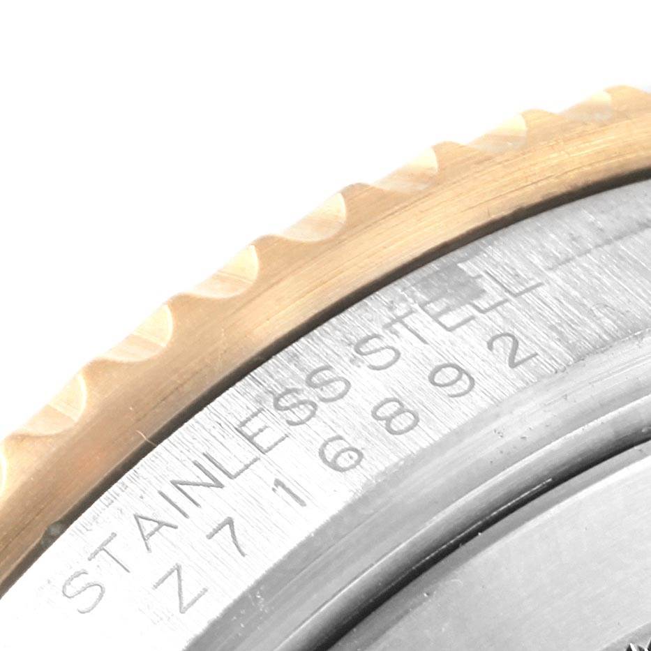 This close-up image shows the bezel and part of the engraved stainless steel case on a Rolex Submariner 16613 Men's Steel and Gold (two tone) Black Dial 16613 Men's Steel and Gold (two tone) Black Dial watch.