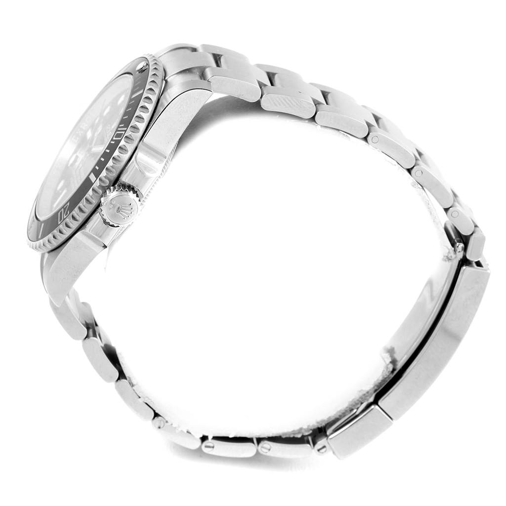 This side view of a Rolex Submariner 114060 Men's Stainless Steel Black Dial 114060 Men's Stainless Steel Black Dial watch shows the bezel, crown, and Oyster bracelet.