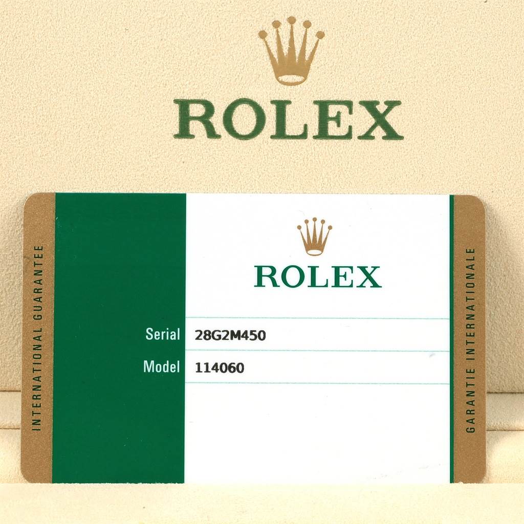 The image shows an international guarantee card for a Rolex Submariner 114060 Men's Stainless Steel Black Dial 114060 Men's Stainless Steel Black Dial model 114060, displaying the serial number.