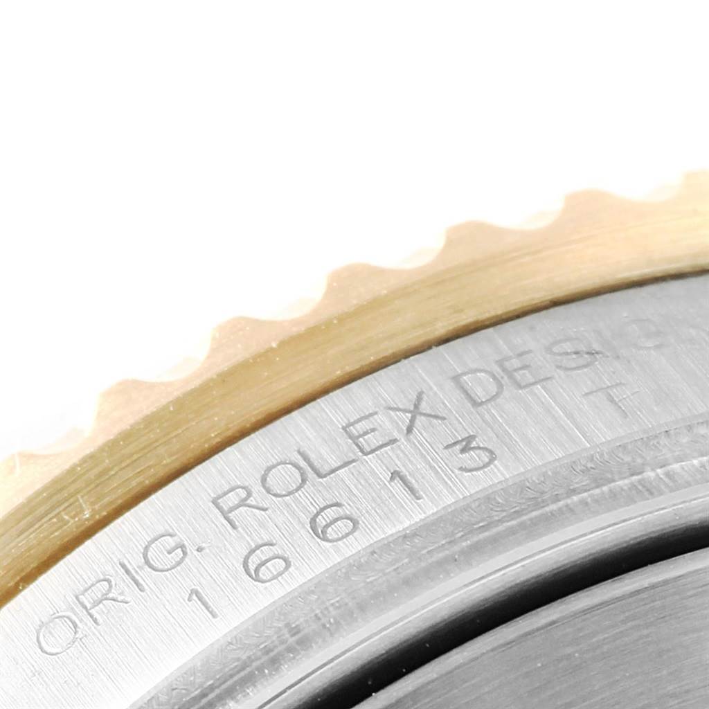 The image shows a close-up of the bezel and engraved case back of the Rolex Submariner 16613 Men's Steel and Gold (two tone) Blue Dial 16613 Men's Steel and Gold (two tone) Blue Dial watch.