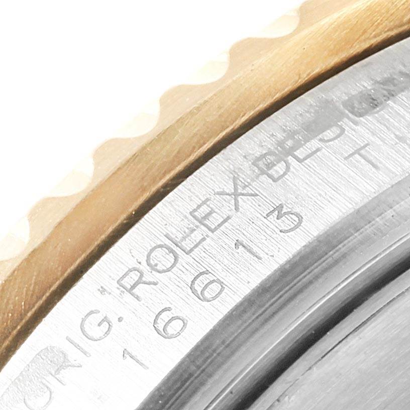 Close-up of the bezel and engraved caseback of a Rolex Submariner 16613 Men's Steel and Gold (two tone) Black Dial 16613 Men's Steel and Gold (two tone) Black Dial watch.