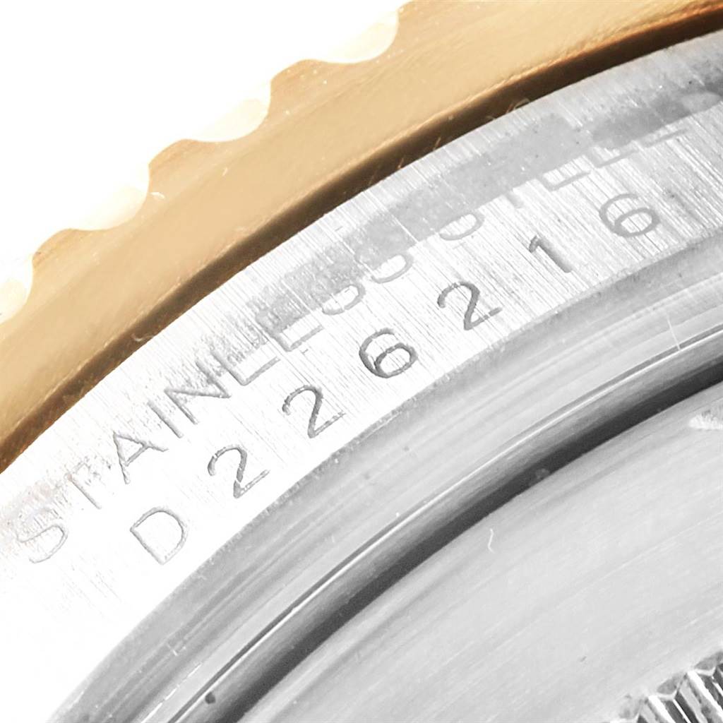 This close-up shot of the Rolex Submariner 16613 Men's Steel and Gold (two tone) Black Dial 16613 Men's Steel and Gold (two tone) Black Dial shows part of the case back and the serial number engraving.