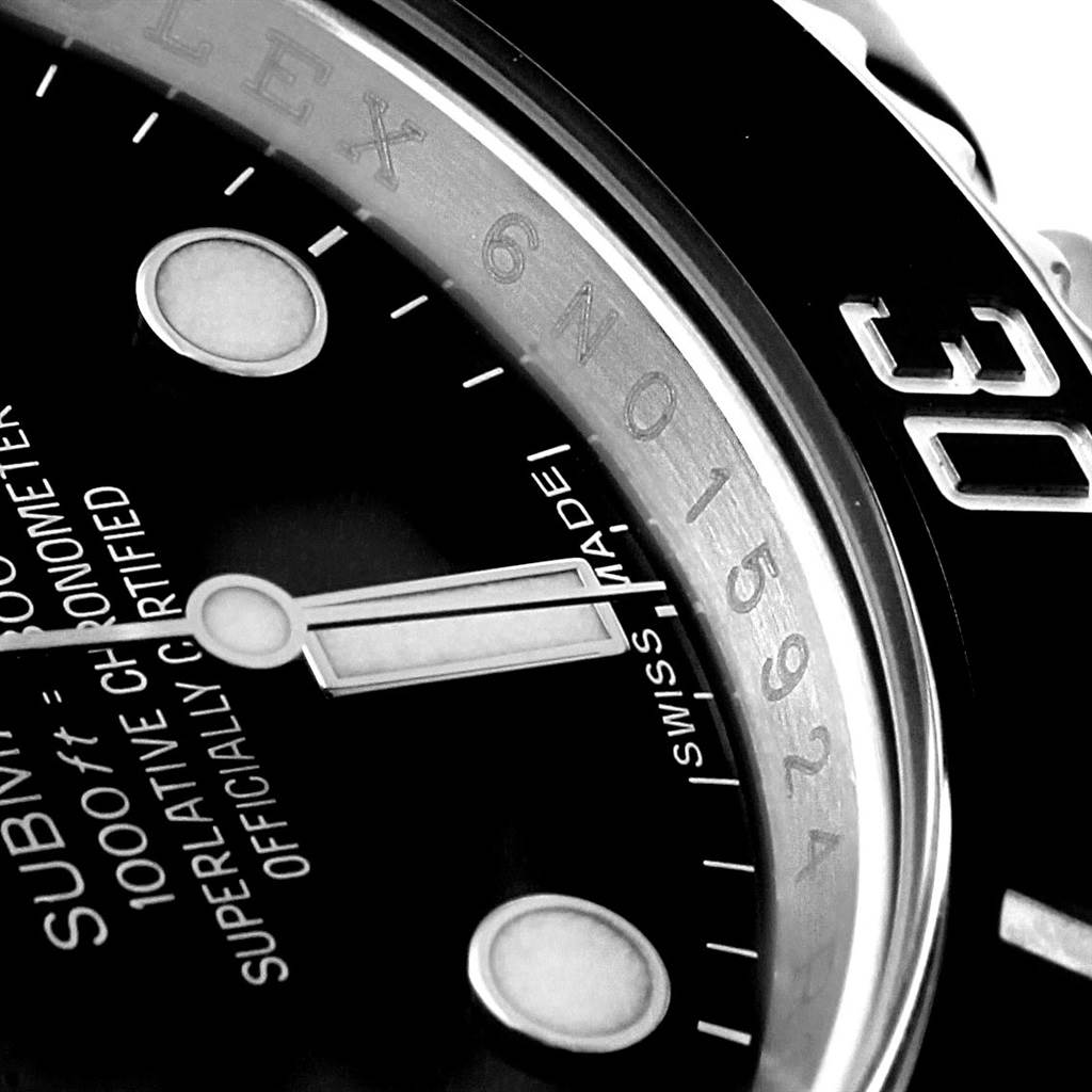 This close-up image shows the face, hands, bezel, and part of the dial of the Rolex Submariner 114060 Men's Stainless Steel Black Dial 114060 Men's Stainless Steel Black Dial.