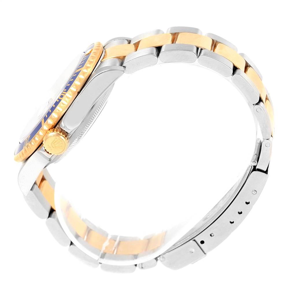 The Rolex Submariner 16613 Men's Steel and Gold (two tone) Blue Dial 16613 Men's Steel and Gold (two tone) Blue Dial watch is shown from a side angle, highlighting its bracelet, crown, and partially visible bezel.
