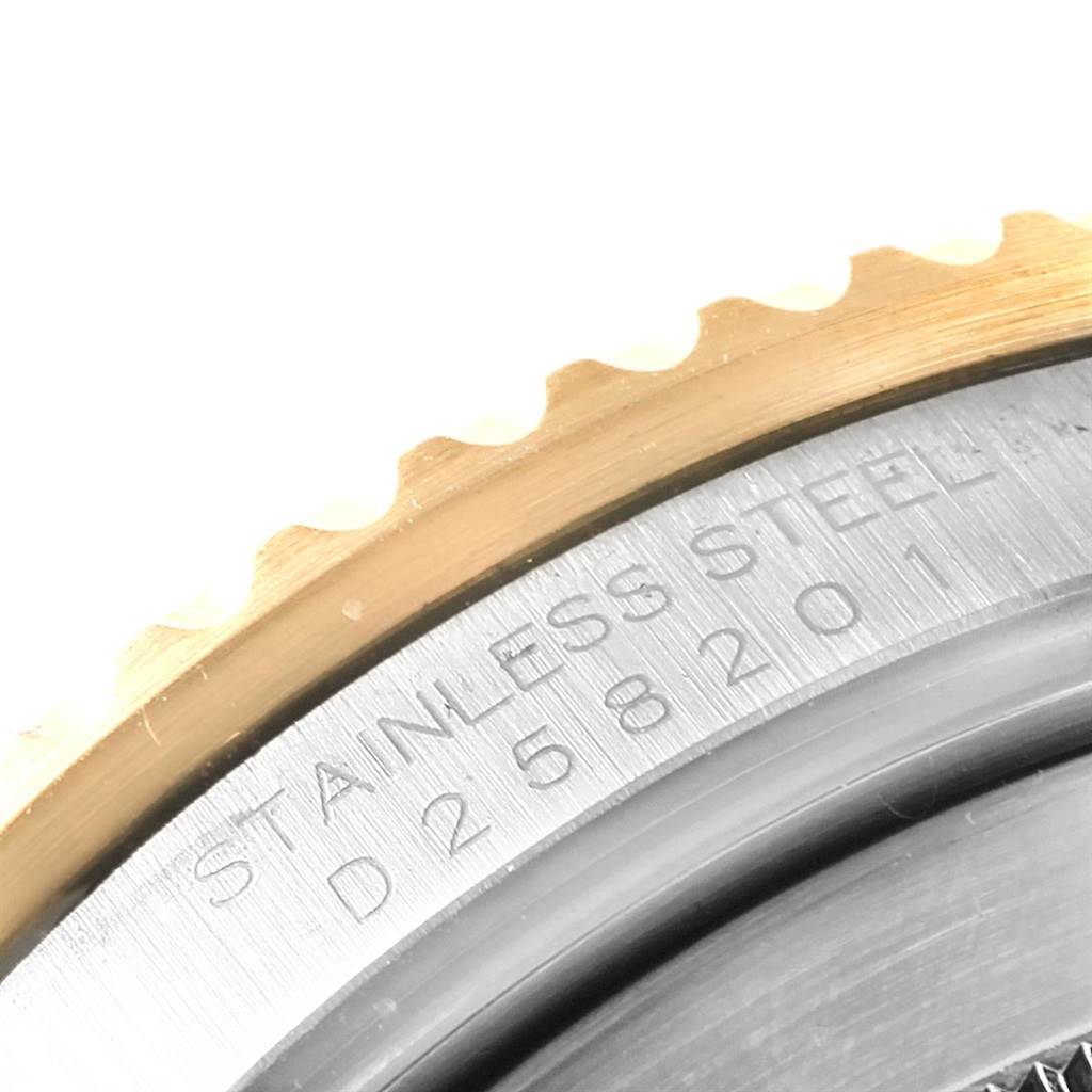 This close-up image shows the edge of the bezel and the stainless steel back of a Rolex Submariner 16613 Men's Steel and Gold (two tone) Blue Dial 16613 Men's Steel and Gold (two tone) Blue Dial watch.