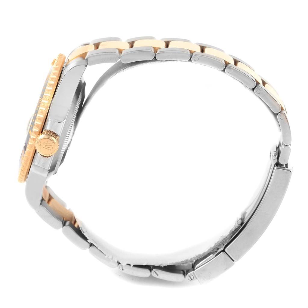 The image shows a side profile of a Rolex Submariner 116613 Men's Steel and Gold (two tone) Black Dial 116613 Men's Steel and Gold (two tone) Black Dial watch, highlighting its case, crown, and two-tone bracelet.