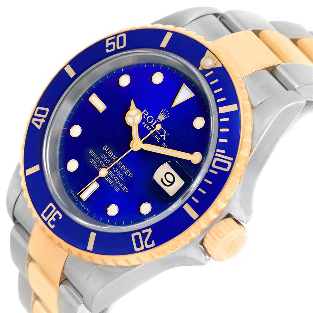 The image shows a Rolex Submariner 16613 Men's Steel and Gold (two tone) Blue Dial 16613 Men's Steel and Gold (two tone) Blue Dial watch at an angle highlighting the blue dial, gold and silver bracelet, and rotating bezel.