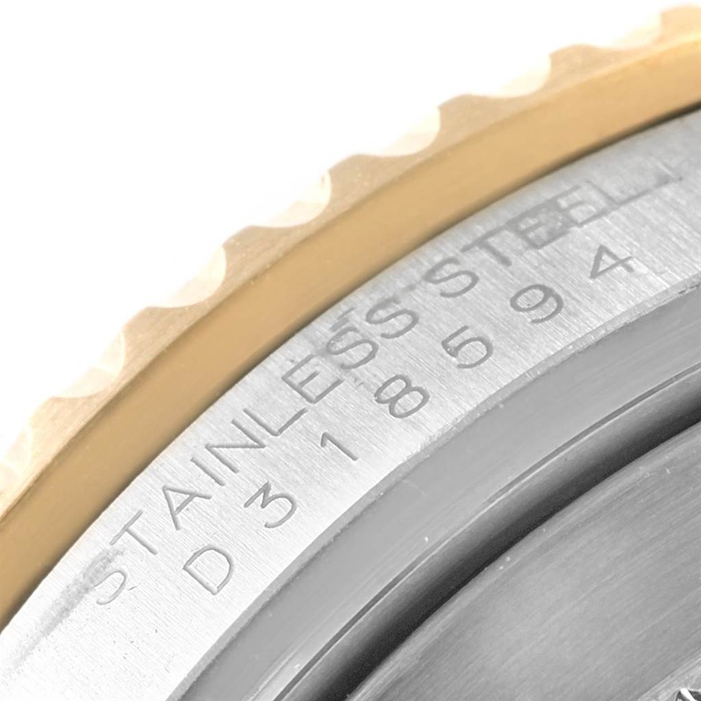 This close-up shows the serial number and stainless steel marking on the case of a Rolex Submariner 16613 Men's Steel and Gold (two tone) Blue Dial 16613 Men's Steel and Gold (two tone) Blue Dial watch.