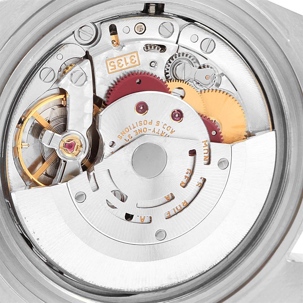The image shows a close-up view of the inner mechanical movement of a Rolex Submariner 16613 Men's Steel and Gold (two tone) Blue Dial 16613 Men's Steel and Gold (two tone) Blue Dial watch.