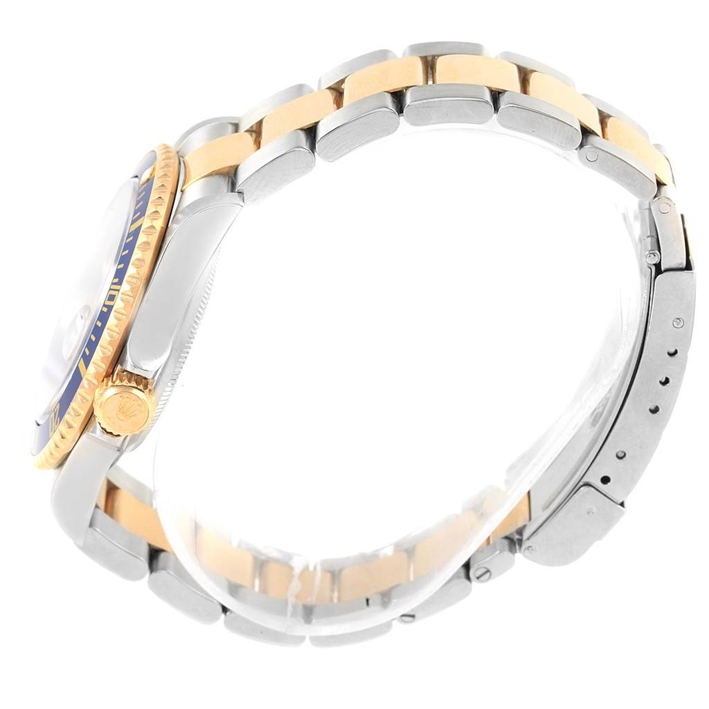 The image shows a side profile of a Rolex Submariner 16613 Men's Steel and Gold (two tone) Blue Dial 16613 Men's Steel and Gold (two tone) Blue Dial, highlighting its two-tone bracelet, bezel, and crown.