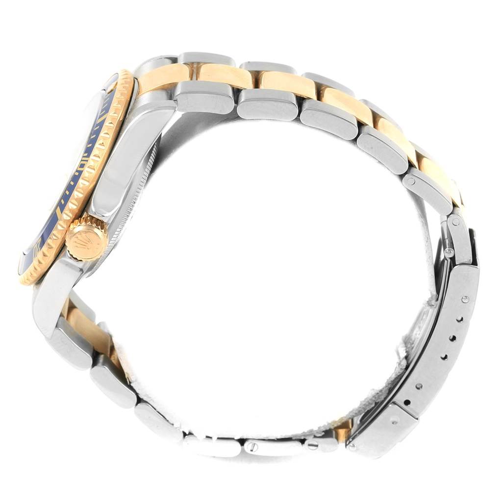 The image shows a side view of the Rolex Submariner 16613 Men's Steel and Gold (two tone) Grey Dial 16613 Men's Steel and Gold (two tone) Grey Dial watch, focusing on its bezel, crown, and two-tone bracelet.