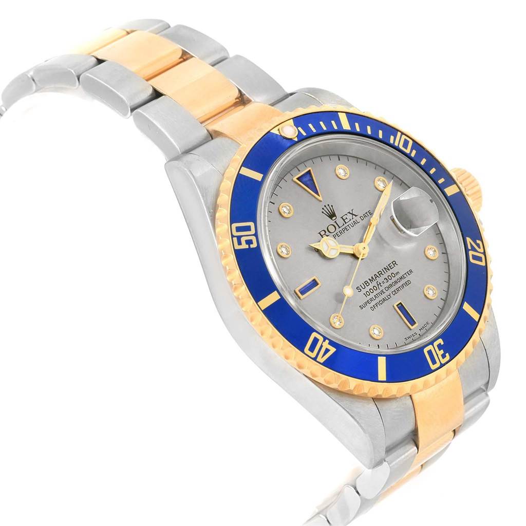 The image shows a three-quarter angle view of a Rolex Submariner 16613 Men's Steel and Gold (two tone) Grey Dial 16613 Men's Steel and Gold (two tone) Grey Dial watch, showcasing its face, bezel, and part of the bracelet.