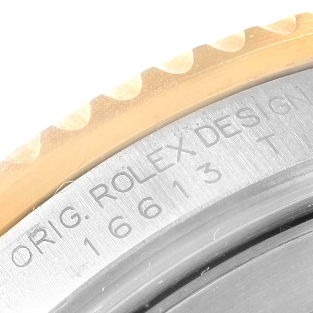 The image shows a close-up of the Rolex Submariner 16613 Men's Steel and Gold (two tone) Grey Dial 16613 Men's Steel and Gold (two tone) Grey Dial bezel and case with the model number 16613.