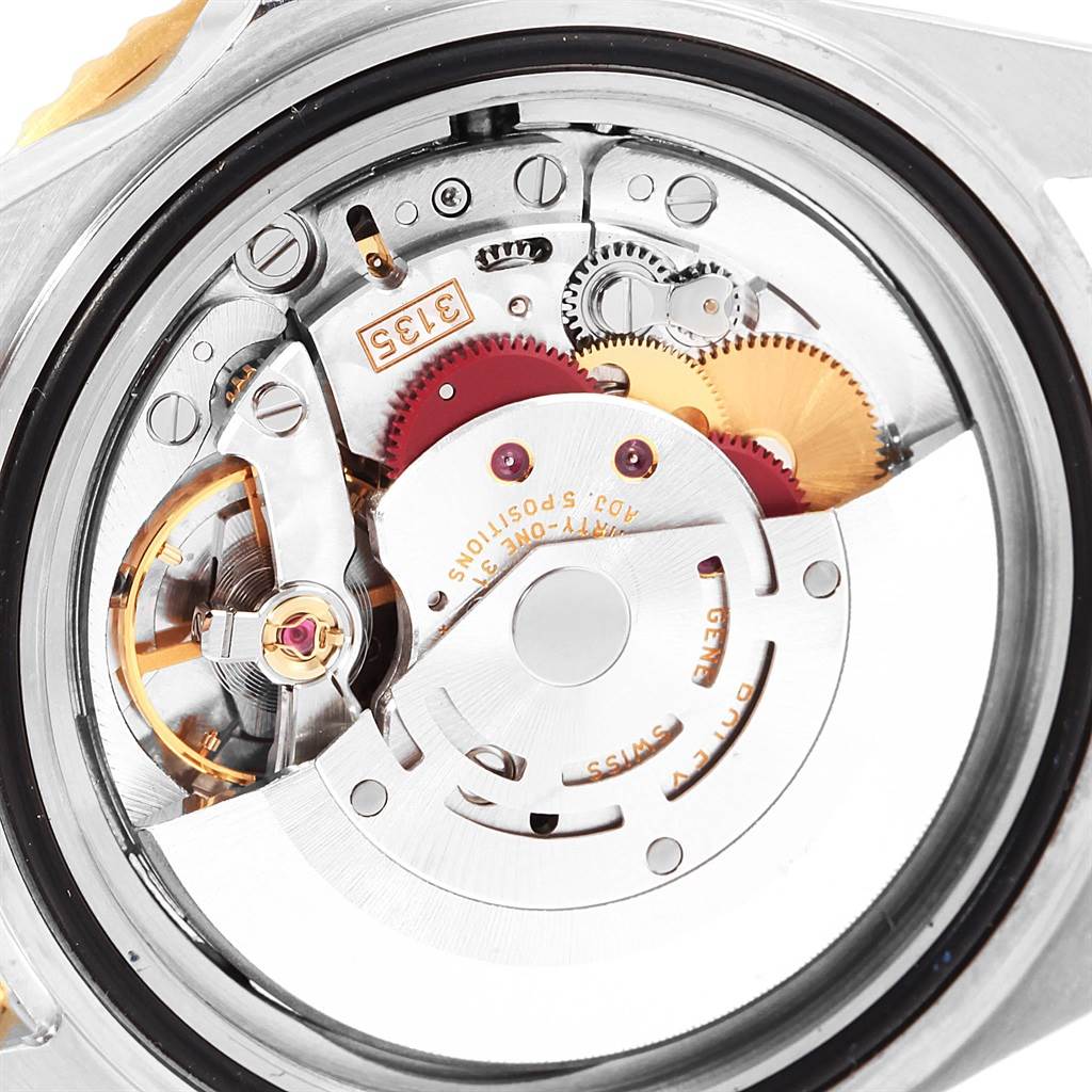 The image shows a close-up of the internal mechanical movement of a Rolex Submariner 16613 Men's Steel and Gold (two tone) Champagne Dial 16613 Men's Steel and Gold (two tone) Champagne Dial watch, highlighting gears and intricate details.