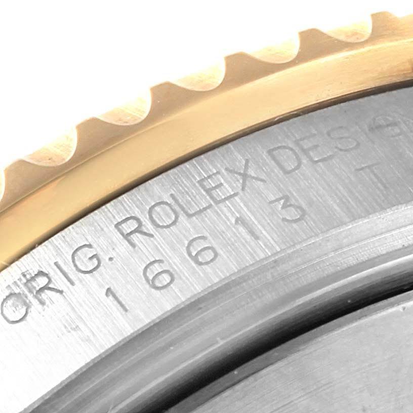 The image shows a close-up of the bezel and case side of a Rolex Submariner 16613 Men's Steel and Gold (two tone) Blue Dial 16613 Men's Steel and Gold (two tone) Blue Dial, featuring engraved model details.