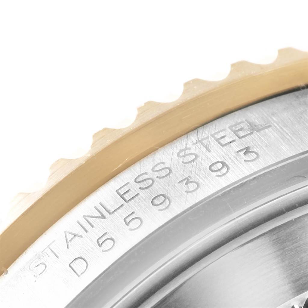 The image shows a close-up of the engraved stainless steel case and bezel of a Rolex Submariner 16613 Men's Steel and Gold (two tone) Blue Dial 16613 Men's Steel and Gold (two tone) Blue Dial watch.