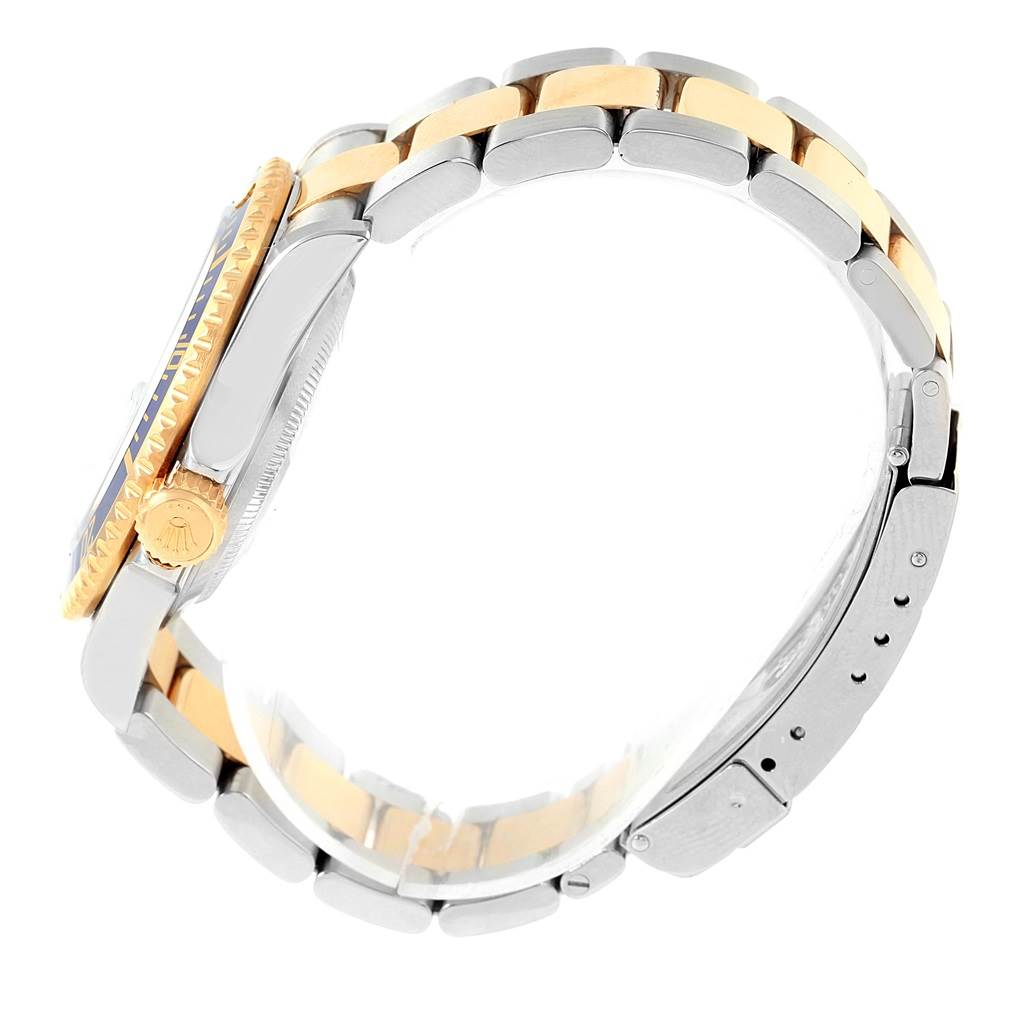 The image shows a side view of a Rolex Submariner 16613 Men's Steel and Gold (two tone) Blue Dial 16613 Men's Steel and Gold (two tone) Blue Dial watch, highlighting its bracelet and crown.