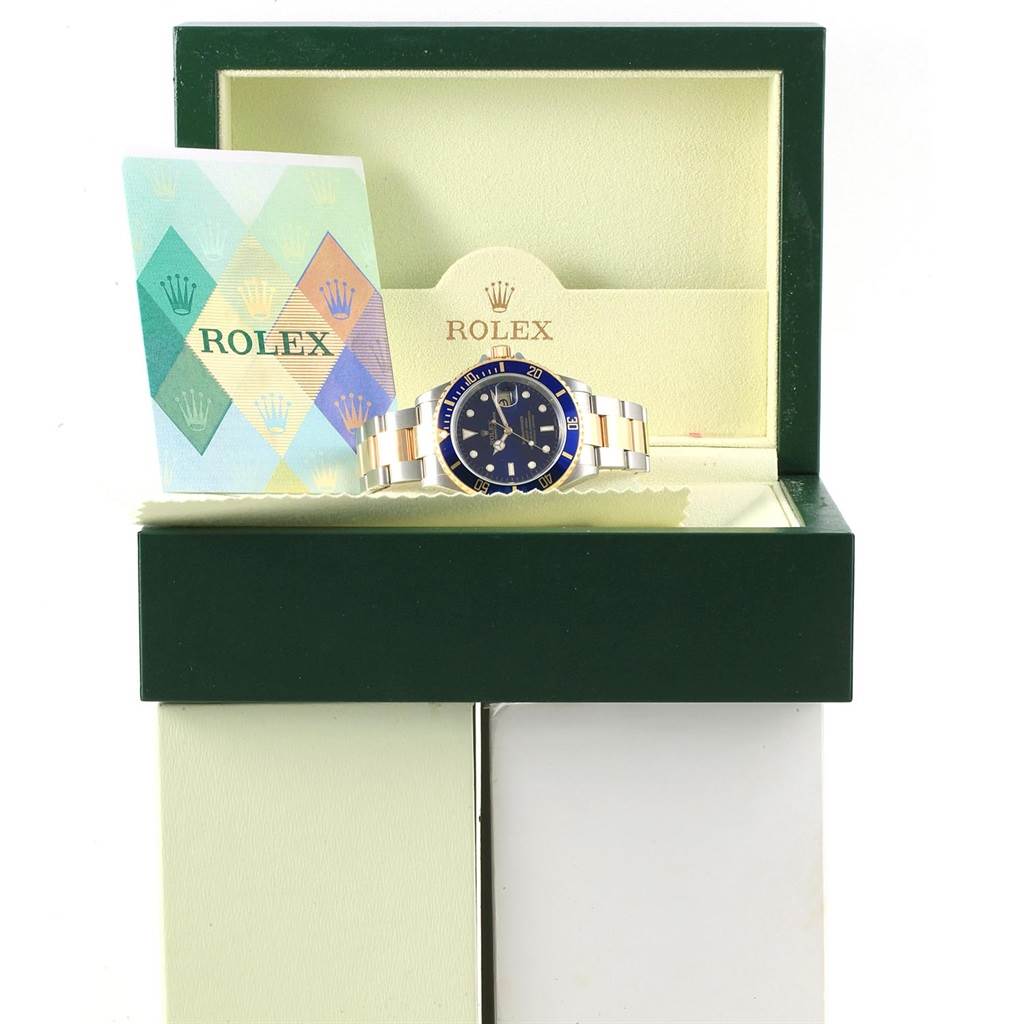 The image displays a Rolex Submariner 16613 Men's Steel and Gold (two tone) Blue Dial 16613 Men's Steel and Gold (two tone) Blue Dial watch inside its open box, accompanied by a warranty card.