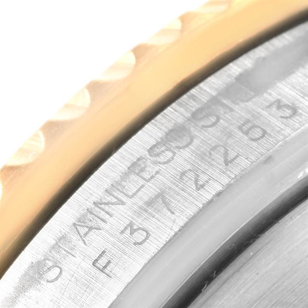 This image shows a close-up of the watch case and bezel of a Rolex Submariner 16613 Men's Steel and Gold (two tone) Blue Dial 16613 Men's Steel and Gold (two tone) Blue Dial.