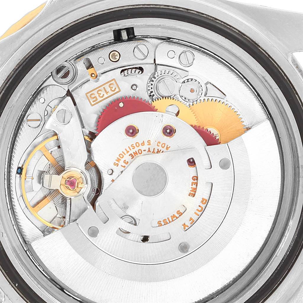 This image shows an internal view of the Rolex Submariner 16613 Men's Steel and Gold (two tone) Blue Dial 16613 Men's Steel and Gold (two tone) Blue Dial watch, highlighting its intricate mechanical movement.