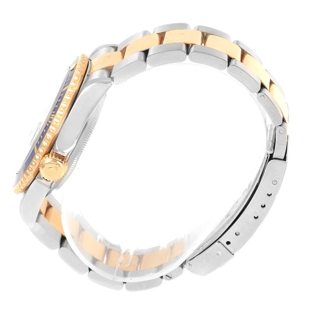 The image shows a side view of the Rolex Submariner 16613 Men's Steel and Gold (two tone) Blue Dial 16613 Men's Steel and Gold (two tone) Blue Dial watch, highlighting its two-tone bracelet and crown.