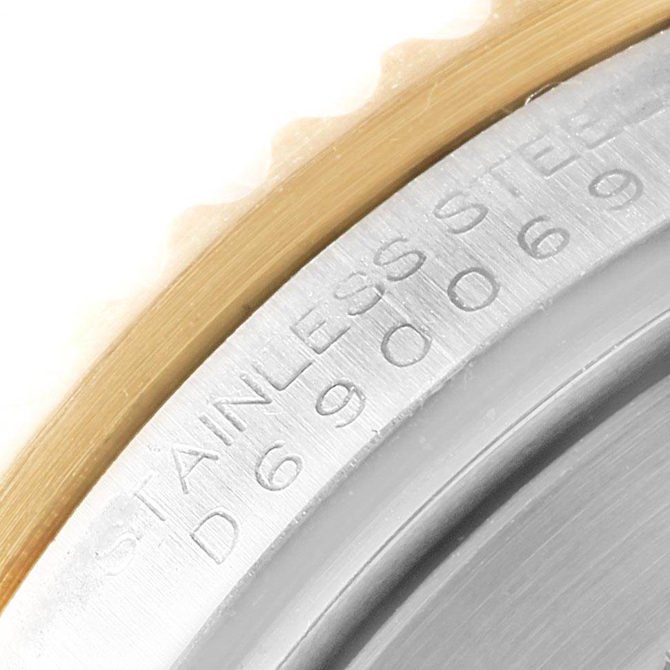 The image shows a close-up of the bezel and part of the caseback of a Rolex Submariner 16613 Men's Steel and Gold (two tone) Blue Dial 16613 Men's Steel and Gold (two tone) Blue Dial watch, highlighting the "STAINLESS STEEL" engraving.